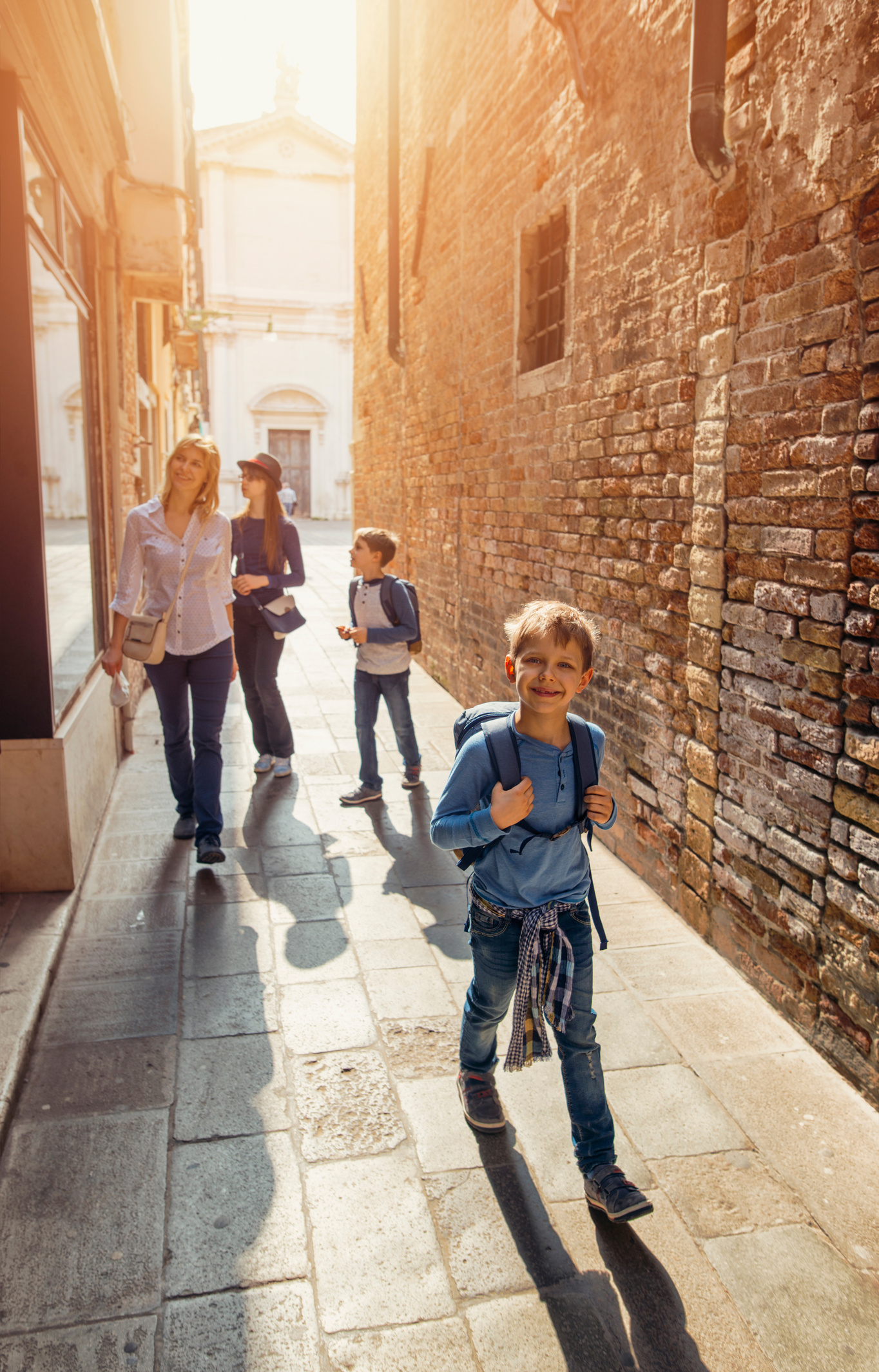 Family walking narrow street of Venice, Italy